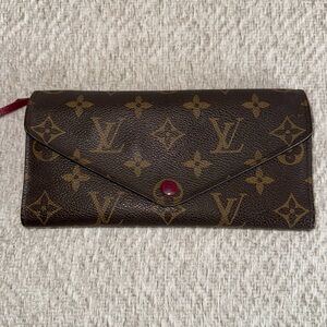 Louis Vuitton trifold wallet. Classic brown and tan LV design pattern.